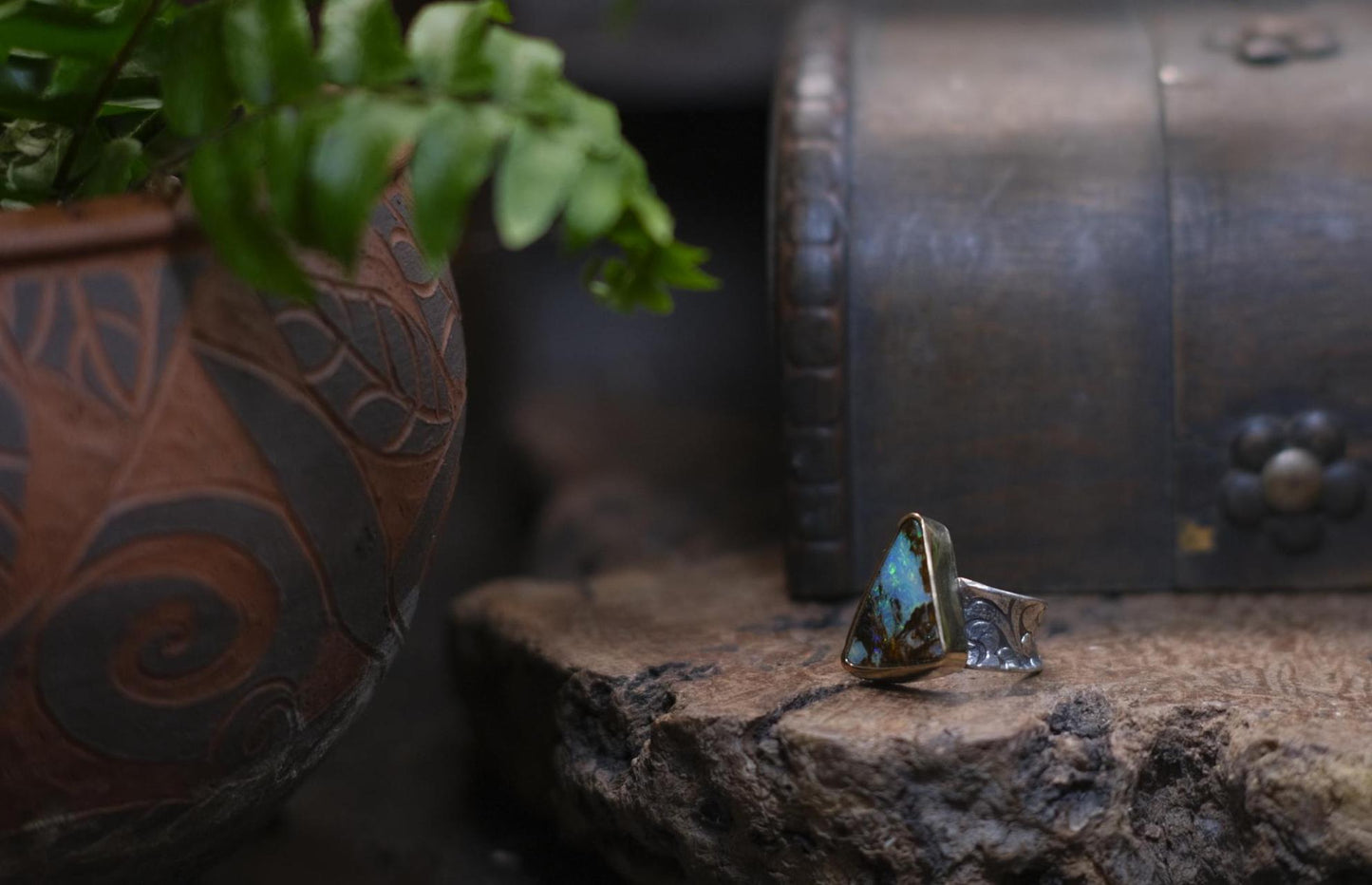 Striking electric blue opalised fossil wood set in 9ct Gold on piratey textured silver band